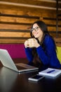 Young lady drink coffee at her working space in modern office Royalty Free Stock Photo