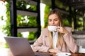 Young woman drinking coffe and looking through a window Royalty Free Stock Photo