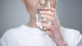 Young lady drinking water, water balance and healthy nutrition, taking medicines