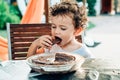 Young lady enjoys a chocolate cake for a snack