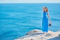 Young lady feeling good enjoying holiday near sea. Panoramic view from mountain. Travel and relax time idea, copy space Royalty Free Stock Photo