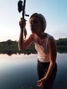 Young lady fishing on the river at sunset Royalty Free Stock Photo