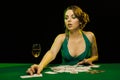 A young lady in a green dress is playing solitaire made from scrying cards Royalty Free Stock Photo