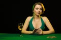 A young lady in a green dress is playing solitaire made from scrying cards Royalty Free Stock Photo