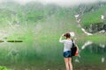 Young lady hiker with backpack sitting on mountain Royalty Free Stock Photo