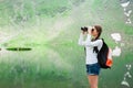 Young lady hiker with backpack sitting on mountain Royalty Free Stock Photo