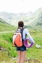 Young lady hiker with backpack sitting on mountain Royalty Free Stock Photo