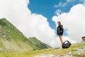 Young lady hiker with backpack sitting on mountain Royalty Free Stock Photo