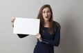 Young lady holding blank board or paper for a commercial Royalty Free Stock Photo