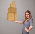 Young lady holding a set of brown cardboard boxes Royalty Free Stock Photo