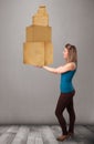 Young lady holding a set of brown cardboard boxes Royalty Free Stock Photo