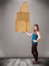 Young lady holding a set of brown cardboard boxes Royalty Free Stock Photo