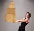 Young lady holding a set of brown cardboard boxes Royalty Free Stock Photo