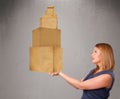 Young lady holding a set of brown cardboard boxes Royalty Free Stock Photo