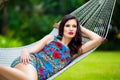 Young lady with long dark hair relaxing in hammock on the tropic Royalty Free Stock Photo