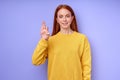 young lady with long straight hair dressed in yellow stylish sweater showing f