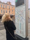 Young lady looking at transport map