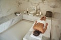 Young lady lying alone in the marble room of Turkish bath Royalty Free Stock Photo