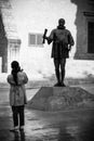 Young lady making snaps of statue in Valletta capital city of Malta