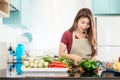 Young lady in modern bright kitchen prepare food