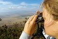 Young lady observing nature with binoculars