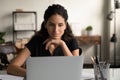 Young lady office worker doing interesting job on laptop online Royalty Free Stock Photo