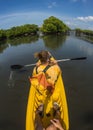 Young lady paddling hard the sea kayak with lots Royalty Free Stock Photo
