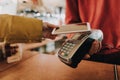 Young lady pay bill via contactless payments