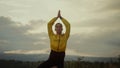 Young lady performing yoga in tree pose. Athletic girl doing yoga in mountains Royalty Free Stock Photo