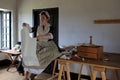 Young lady in period clothes, sewing clothes for soldiers, Fort Ticonderoga, New York, 2016