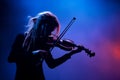 Young lady playing violin on scene. Generative AI