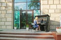 Young lady plays the piano outdoors on the day of the Museum in Volgograd