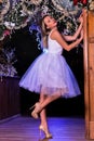 Young lady posing in front of Christmas hall decorations