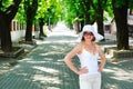 Young lady posing on pave alley