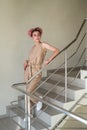 Young lady posing on the stairs inside building Royalty Free Stock Photo