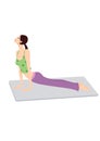 Young lady practicing yoga exercise on mat