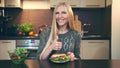 Young lady preferring hamburger to salad.