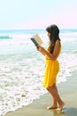 Young lady reading a book on the beach Royalty Free Stock Photo