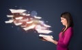 Young lady reading a book with flying sheets coming out of the b Royalty Free Stock Photo