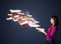 Young lady reading a book with flying sheets coming out of the b Royalty Free Stock Photo