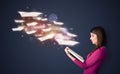 Young lady reading a book with flying sheets coming out of the b Royalty Free Stock Photo