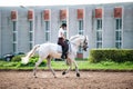 Young lady riding a horse at equestrian school. Training process