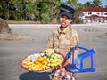 Young lady sells fresh fruit along the beach