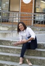 Young lady.She sit on the concrete Novi Sad Serbia.Holds on to the foot which is very sore.