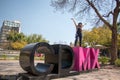 Young lady standing on the CDMX sculpture in la Condesa