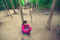 Young lady sitting on the ground inside of Ta Som