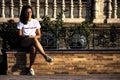 Young lady sitting outdooors in a summer morning