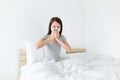 Young lady sneeze on the bed and need more rest Royalty Free Stock Photo