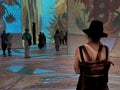 A woman contemplates Van Gogh display in a large travelling art show