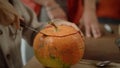 A young lady is starting to carve a pumpkin for Halloween